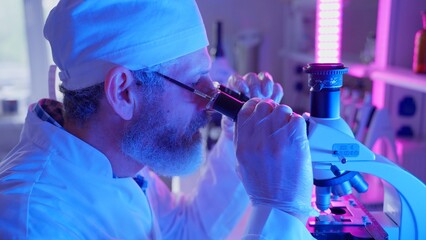 Chemist Analyzing Samples in Innovative Laboratory With Neon Purple Technology