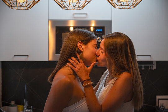 Intimate moment between lesbian couple in a modern kitchen