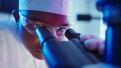 Research Chemist Analyzing Chemical Samples in Neon-Lit Laboratory Environment