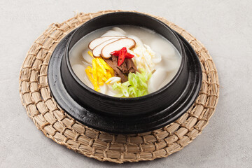 Tteokguk is a food made by thinly slicing rice cakes diagonally and boiling them in clear soybean soup.