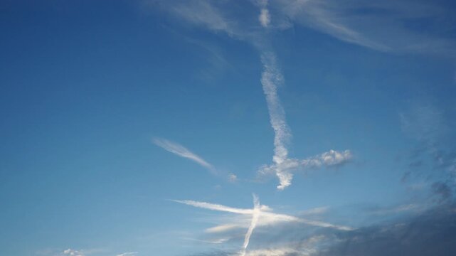 Plane leaves condensation trail. Chemtrail conspiracy theory. Long-lasting condensation trails left in sky by high-flying aircraft are actually chemtrails consisting of chemical or biological agents