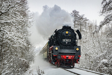 German steam express locomotive driving through a snowy family © sever07