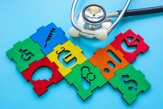 Concept of healthcare business ideas. Stethoscope and pieces of medical and financial puzzle.