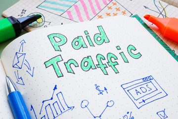Notebook with charts and words paid traffic. Analysis of advertising performance and digital...