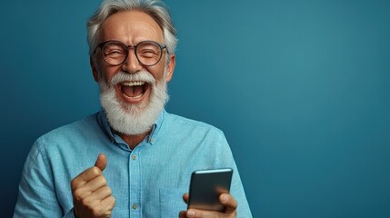A cheerful older man laughs heartily while holding his smartphone, enjoying a delightful moment