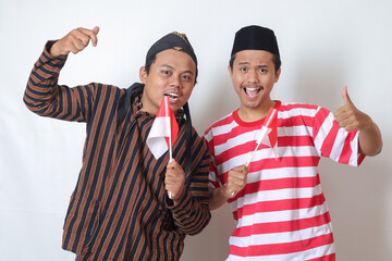 Portrait of two excited Asian man from Javanese and Madurese tribes celebrating independence day on...