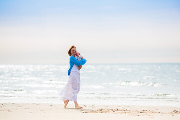 Mother and child on beach. Vacation with baby.