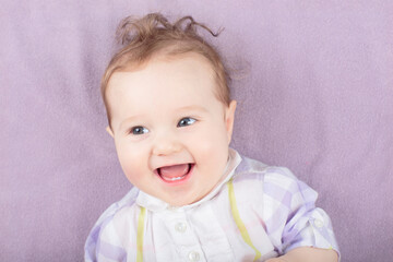 Naklejka premium Little baby on white bed