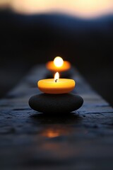 Zen candle arrangement on stones with a serene twilight backdrop