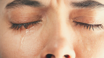 Close-up shot of young crying woman	

