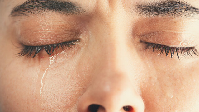 Close-up shot of young crying woman	
