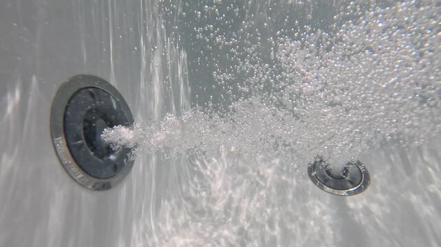 Underwater video of jacuzzi jets releasing air bubbles perfect for massage spa and well being