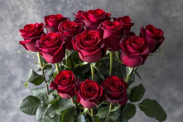 Fototapeta premium Stunning Arrangement of Fresh Red Roses in a Bouquet With Green Leaves