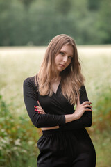 Portrait of a young beautiful long-haired girl in nature.