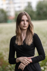 Portrait of a young beautiful long-haired girl in nature.