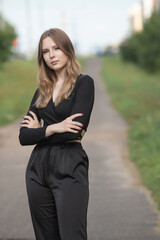 Obraz premium Portrait of a young beautiful long-haired girl in nature.