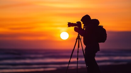 Photographer shooting sunrise on beach with tripod and camera. Hobby and solitary