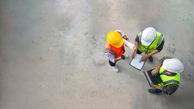 Top view of architects engineer are discussing about the progress of the building project and checking the accuracy of the building structure.