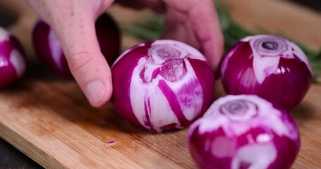 peeled red onions on a chopping board, preparing red onions for cooking in dishes