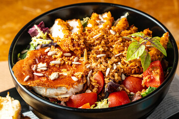 Spectacular salad with breaded chicken, seeds, tomato and sprouts
