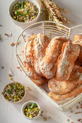 Tasty and healthy sprouts buns freshly baked on wooden board.