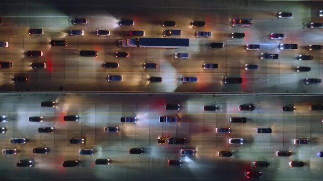A 4K aerial image captures heavy traffic congestion in Downtown Los Angeles, California, USA, showing the chaotic city commute and bustling streets, with a busy urban scene full of cars and trucks