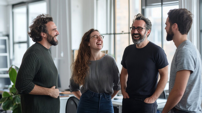 Portraits of a group of businesspeople standing together in an office, laughing and engaging in lively conversation. The image captures the camaraderie and positive communication a