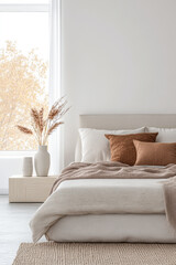 Modern Scandinavian luxury bedroom interiors with an elegant bed and minimal decoration next to a large window.