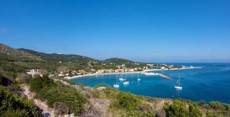 Fototapeta premium Amazing view down to the sea and the harbor village from the mountain in Othonoi island, Greece