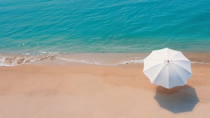 White Umbrella on Sandy Beach With Turquoise Water Under Clear Sky