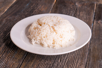 White rice in bowl on wood table
