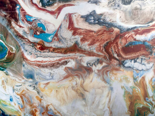 Beautiful abstraction of liquid paints in slow blending flow mixing together gently