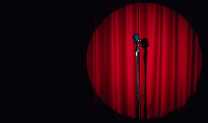 Concept stand up, comedian show banner. Old microphone on theater stage on red curtains background