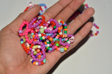 Beading workplace with hands in the process of handicraft. Beautiful diy jewelry and calming stress releasing hobby and activity