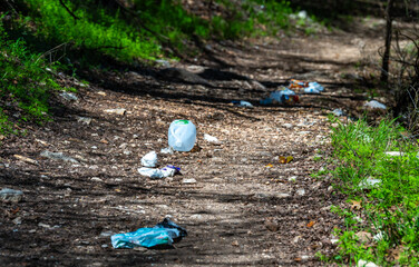 Trail with litter: plastic cups, packaging, plastic bag, bottle, Colorado Bend State park, TX