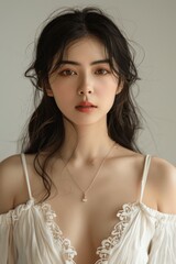 Beautiful Asian Woman with Long Black Hair in White Dress, Natural Skin Tone, Studio Lighting, Soft Focus
