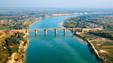 Naklejka premium Aerial View of Newly Constructed Bridge Connecting Two Countries Highlighting Connectivity and Trade Routes Under China's Investments