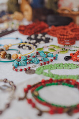 Handmade gemstone jewelry displayed at a vibrant market stall during a sunny afternoon