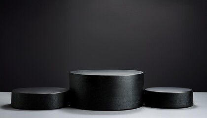 three black podiums on a dark background for various products