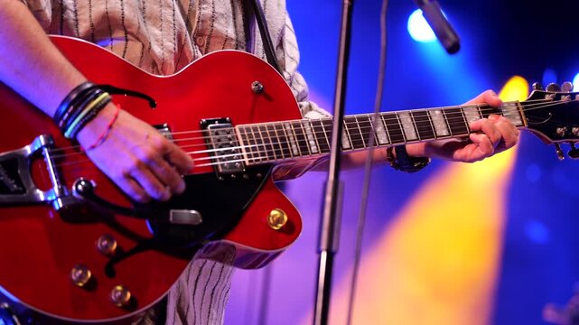 Man playing the guitar on stage, horizontal video 