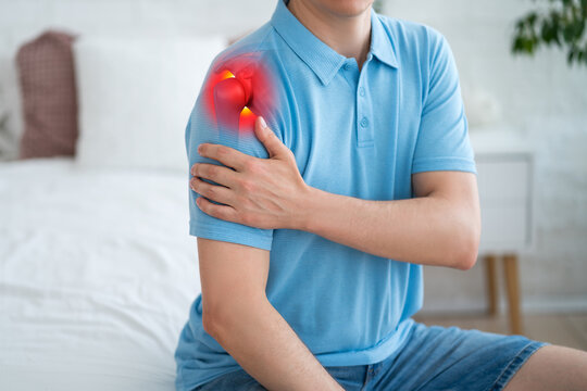 Dislocation of the shoulder, joint inflammation, arthritis and degenerative changes, man with pain in hand at home
