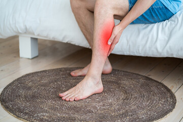 The man's calf muscle cramped, massage of male leg