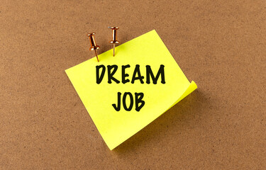 DREAM JOB text on yellow sticky on board background