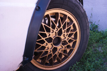 old retro titanium bronze car rims in the yard in summer