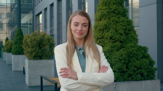 Confident smiling Caucasian woman blonde businesswoman employee student in formal suit looking at camera outdoors city downtown. Happy female hr manager crossing arms girl posing nod business success