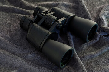 black binoculars on grey background studio shot