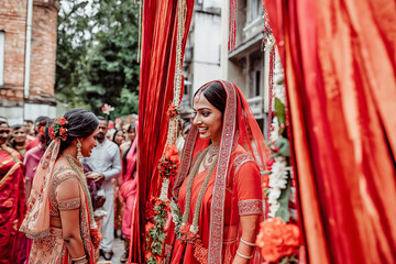 Fototapeta premium Group in traditional attire, young woman leading rituals at riverside