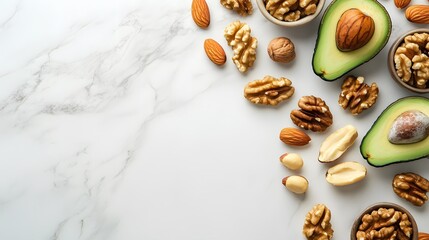 Obraz premium Healthy fats composition on white marble background, sliced avocado, assorted nuts, walnuts, almonds, pecans, food photography, nutritious ingredients, keto diet, vegan protein sources.