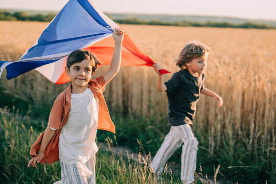 Cute Little Boys - French Patriot Kids Running With National Flag On Open Area - Powered by Adobe