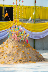Sculpture of Buddha and pagoda from sand and flowers, tradition of transporting sand to temples, Thailand